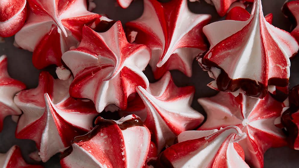 red and white swirled peppermint meringues dipped in chocolate and crushed peppermint