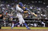 Los Angeles Dodgers' Chris Taylor hits an RBI single against the Arizona Diamondbacks during the second inning of a baseball game Saturday, July 31, 2021, in Phoenix. (AP Photo/Rick Scuteri)