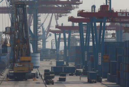 Trucks unload a ship in Tanjung Priok Port in North Jakarta, Indonesia May 26, 2017. REUTERS/Darren Whiteside