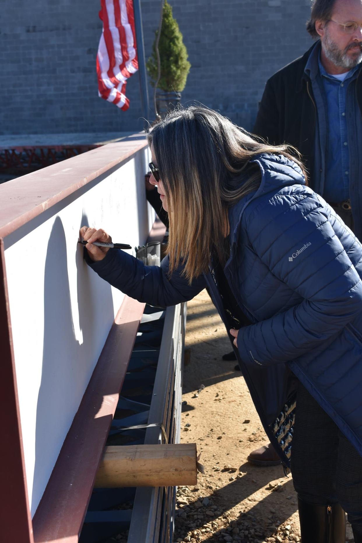 Roane Alliance President Pam May signs the beam of the Emergency Response Training Facility in west Oak Ridge on Jan. 11, 2022.  The state-funded ERTF will be part of the Oak Ridge Enhanced Technology and Training Center.