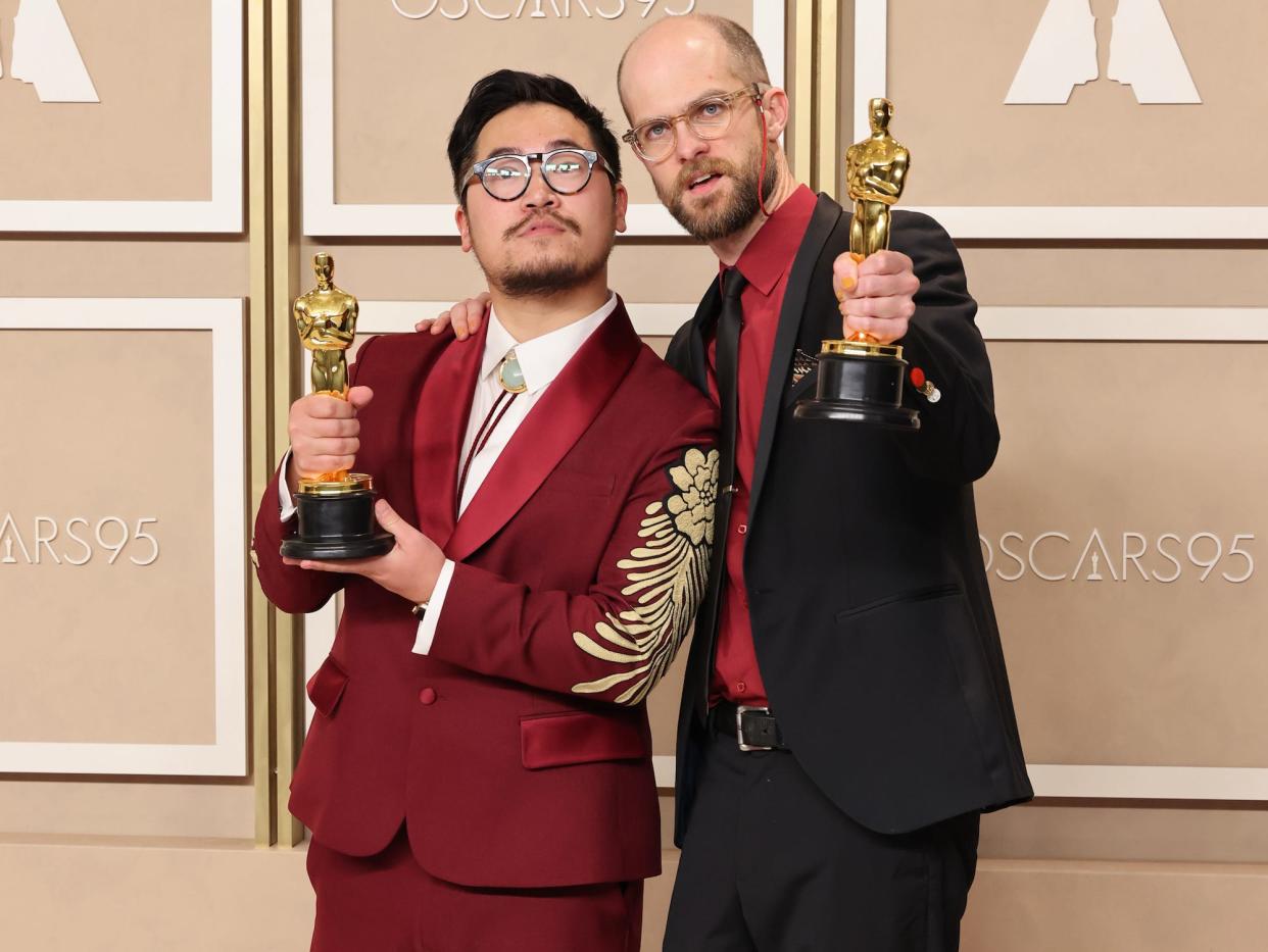 Daniel Kwan and Daniel Scheinert pose with their 2023 Oscars.