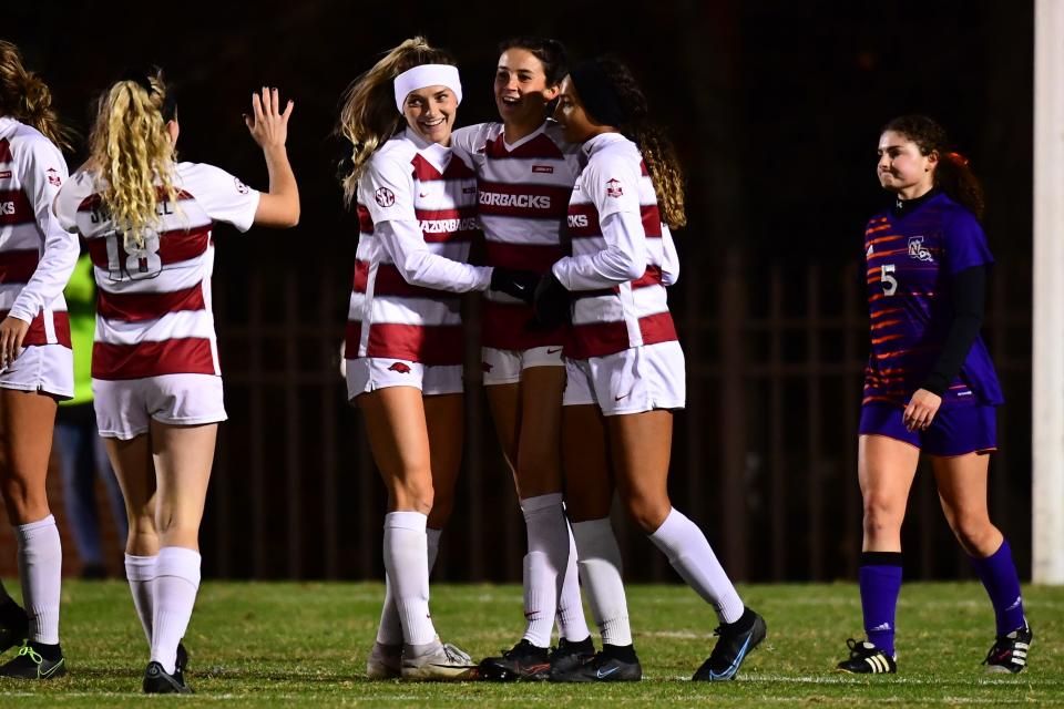 Arkansas defender Reagan Swindall (18) celebrates with teammates. The Arkansas Razorbacks women's soccer team defeated Northwestern State 5-1 during the NCAA Tournament first-round match on Friday, Nov. 12, 2021, in Fayetteville, Arkansas.