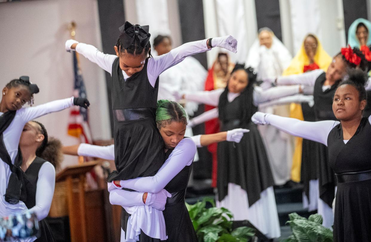 Mariah Lamarr holds up Payton Anderson, 9, as they perform with the Butterflies and Our Steps Are Ordered Dance Ministry during a special Easter performance presented Palm Sunday, March 24, at the Family Missionary Baptist Church in Columbus.