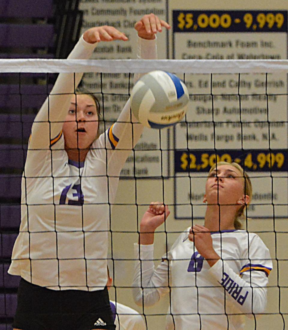 Watertown's Carter Jurrens (13) puts one down as teammate Emily Tisher looks on during their high school volleyball match on Tuesday, Sept. 12, 2023 in Watertown.