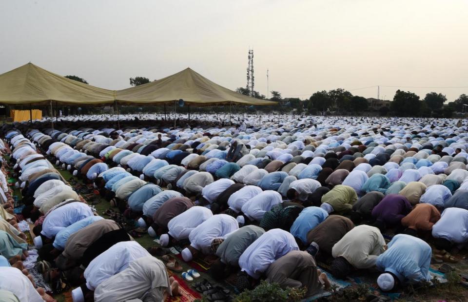 Pakistani residents offer Eid al-Fitr prayers on the outskirts of Peshawar (AFP/Getty Images)