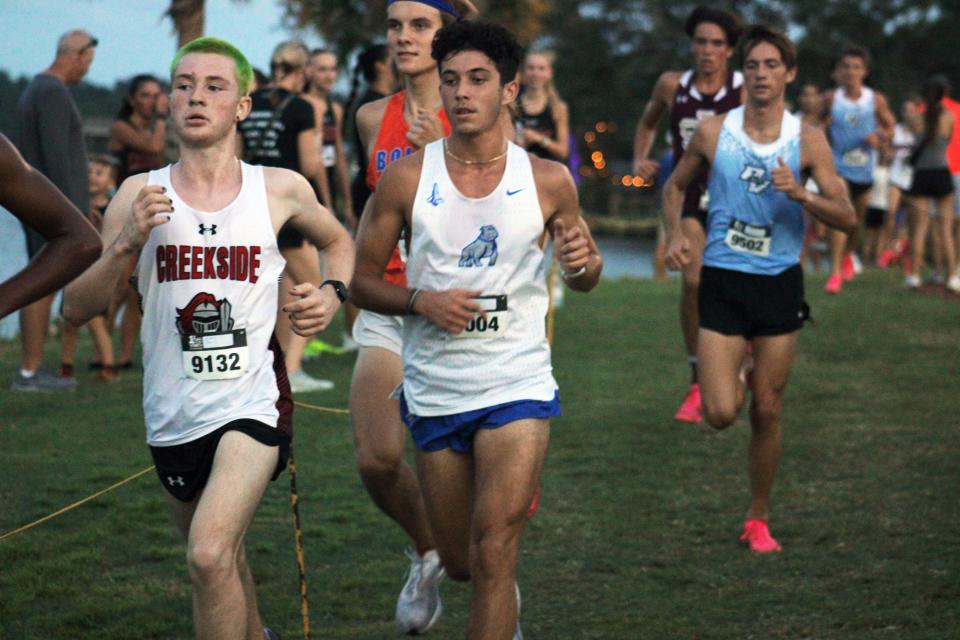 Creekside's Jack Zurn (left) heads a pack of runners at the Katie Caples Invitational in September.