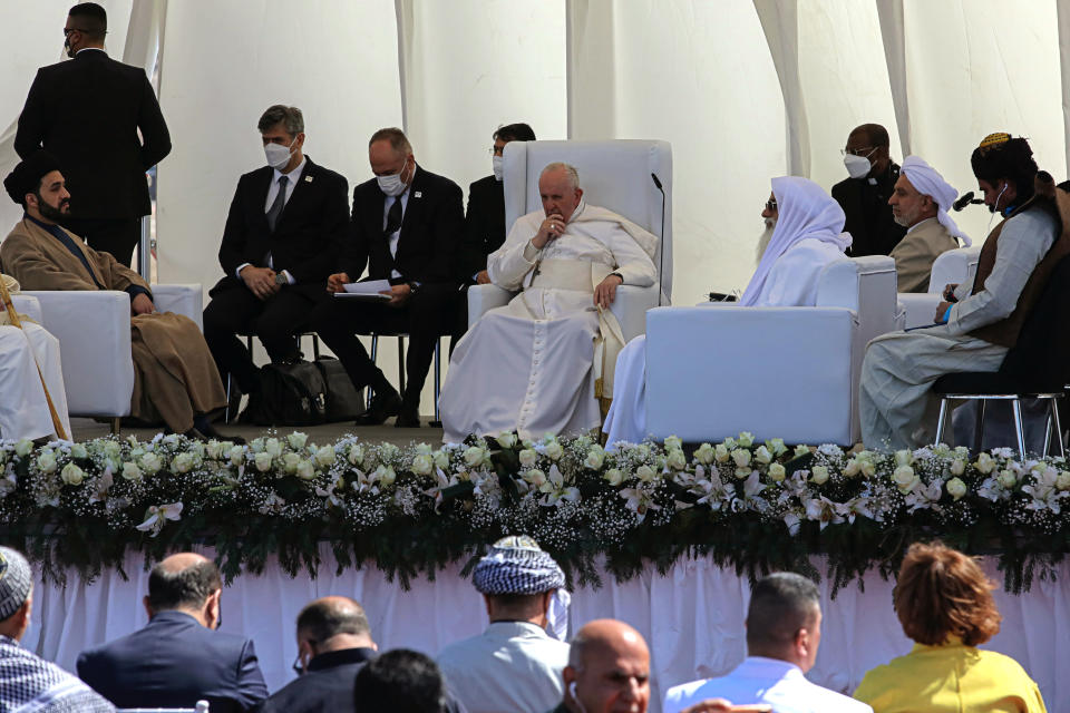 Pope Francis, center, listens during an interreligious meeting near the archaeological site of Ur near Nasiriyah, Iraq, Saturday, March 6, 2021. Pope Francis and Iraq's top Shiite cleric delivered a powerful message of peaceful coexistence Saturday, urging Muslims in the war-weary Arab nation to embrace Iraq’s long-beleaguered Christian minority during an historic meeting in the holy city of Najaf. (AP Photo/Nabil al-Jourani)