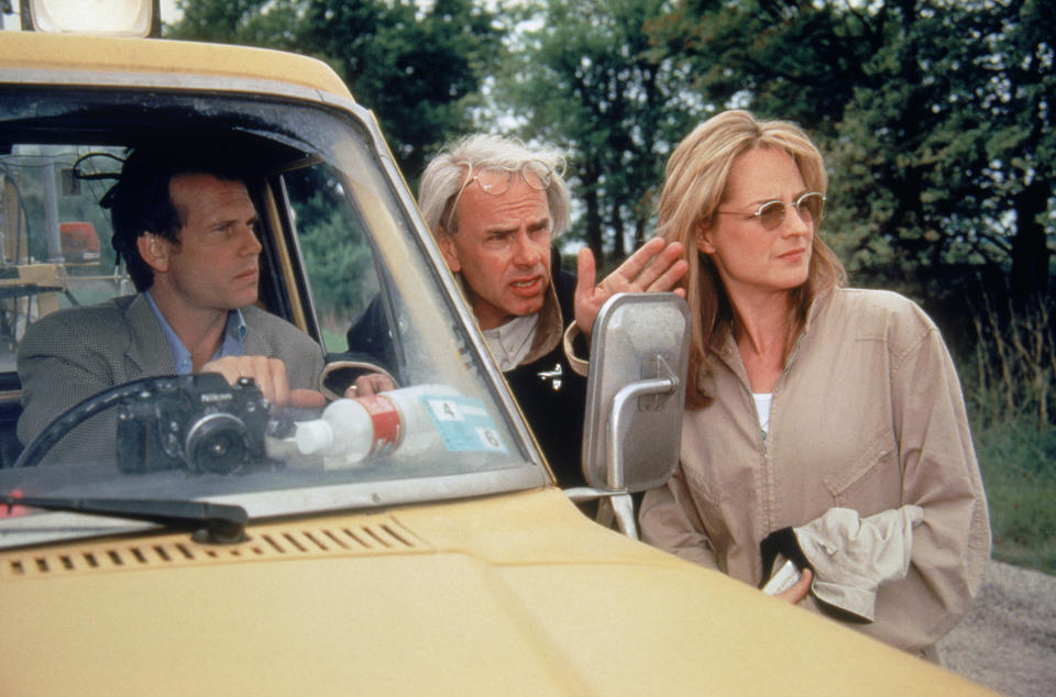 Jan De Bont (centre) giving direction to Bill Paxton and Helen Hunt on the set of Twister. (Warner Bros.)