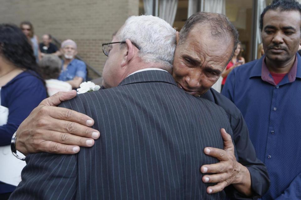 Mahmoud Hassanen Aboras, father of Nabra, gets a hug from Virginia congressman, Gerry Connolly, at a separate vigil (AP)