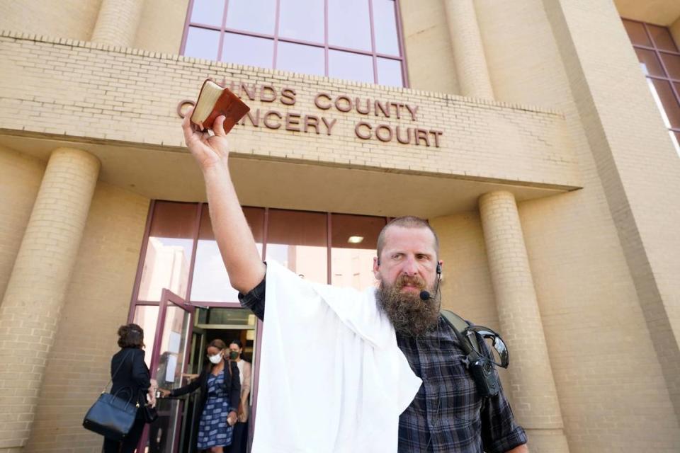 Anti-abortion activist Allen Siders, holds his Bible and calls out at people entering and leaving the Hinds County Chancery Court, a message against abortion and sin, Tuesday, July 5, 2022, in Jackson, Miss., after a hearing in a lawsuit brought by the state’s only abortion clinic that seeks to block a law that would ban most abortions. (AP Photo/Rogelio V. Solis)