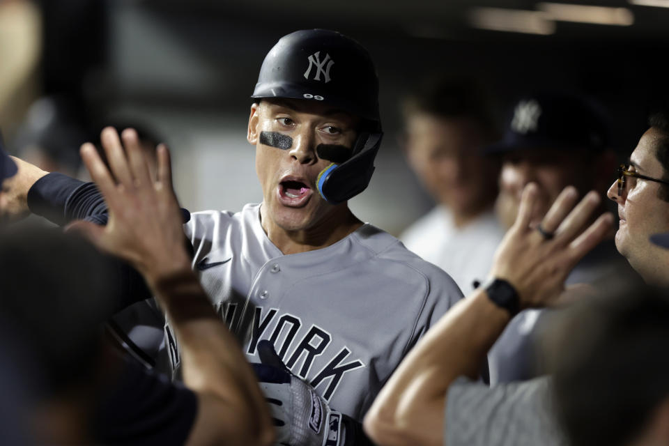 New York Yankees' Aaron Judge celebrates in the dugout after hitting a solo home run on a pitch from Seattle Mariners' Ryan Borucki during the ninth inning of a baseball game, Monday, Aug. 8, 2022, in Seattle. (AP Photo/John Froschauer)