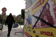 A man walks past a poster in central Athens that reads "Yes to Work. No to the Euro" .