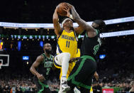 Boston Celtics guard Jrue Holiday (4) blocks a shot by Indiana Pacers forward Bruce Brown (11) during the first half of an NBA basketball game Wednesday, Nov. 1, 2023, in Boston. (AP Photo/Charles Krupa)