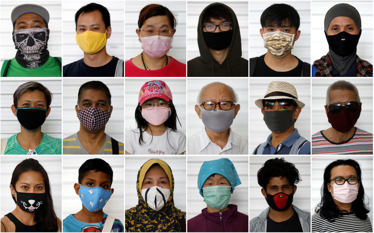 People in face masks posing for photos on their way to the supermarket or bank, on day nine of the "circuit breaker" measures to curb the COVID-19 outbreak in Singapore on 15 April, 2020. (PHOTO: Reuters)