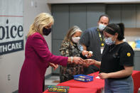 First lady Jill Biden hands a button to a woman who had just gotten his COVID-19 vaccination during a visit to First Choice Community Healthcare - South Valley Medical Center in Albuquerque, N.M., Tuesday, April 21, 2021. (Mandel Ngan/Pool via AP)