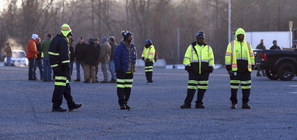 Winston-Salem city workers wait outside the Joycelyn V. Johnson Municipal Services Center after reports of gunshots in Winston-Salem, N.C. early Friday, Dec. 20, 2019. Winston- Salem Police are confirming there was a shooting but are not saying at this time if there are any injuries or deaths. (Walt Unks/Winston-Salem Journal via AP)