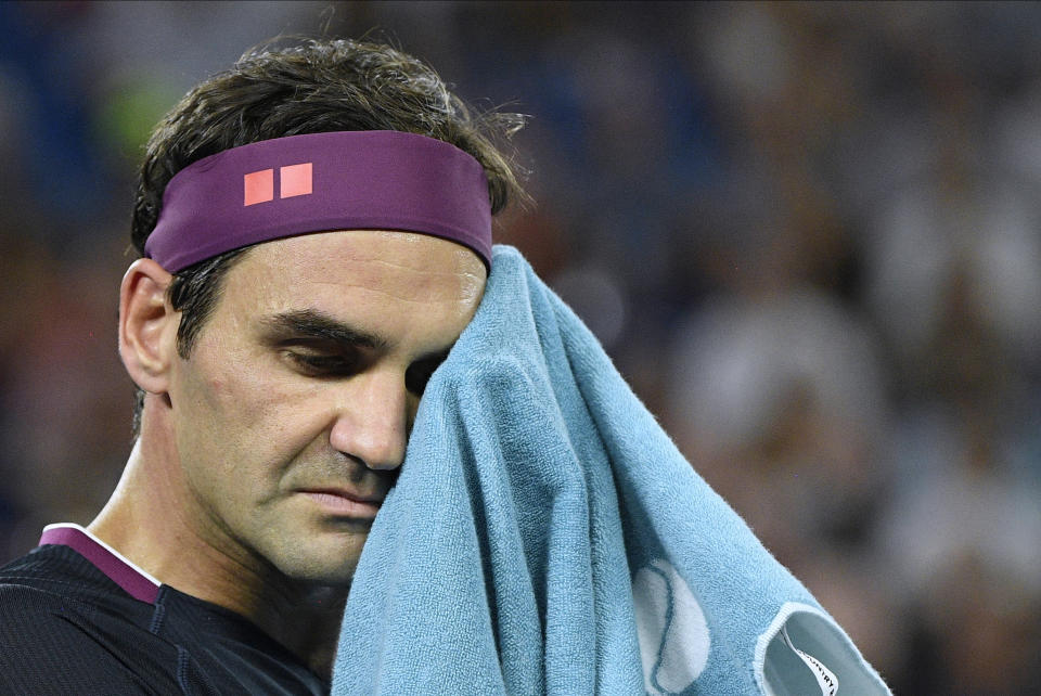 FILE - Switzerland's Roger Federer wipes the sweat from his face during his semifinal match against Serbia's Novak Djokovic at the Australian Open tennis championship in Melbourne, Australia, Thursday, Jan. 30, 2020. Federer announced his retirement shortly after last year’s U.S. Open. The 2023 edition of the tournament begins at Flushing Meadows on Aug. 28. (AP Photo/Andy Brownbill, File)