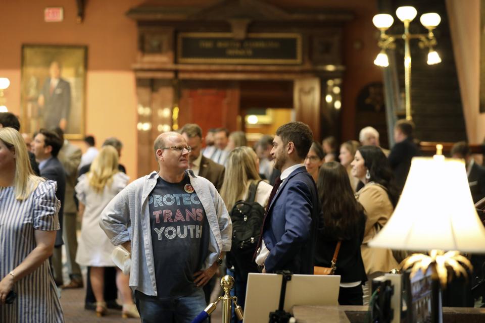 FILE - Brent Cox, left, talks to Josh Malkin, right, of the South Carolina chapter of the American Civil Liberties Union, right, as they wait to talk to lawmakers in the lobby of the Statehouse on Wednesday, May 1, 2024, in Columbia, S.C. South Carolina Gov. Henry McMaster signed into law Tuesday the bill that bans gender-affirming care for transgender minors. (AP Photo/Jeffrey Collins, file)