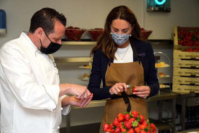 Britain's Catherine, Duchess of Cambridge, Patron of the All England Lawn Tennis Club, talks with with chef Adam Fargin as they prepare strawberries in the Wingfield kitchen during her visit on the fifth day of the 2021 Wimbledon Championships at The All England Tennis Club in Wimbledon, southwest London, on July 2, 2021. - RESTRICTED TO EDITORIAL USE (Photo by John Walton / POOL / AFP) / RESTRICTED TO EDITORIAL USE (Photo by JOHN WALTON/POOL/AFP via Getty Images)