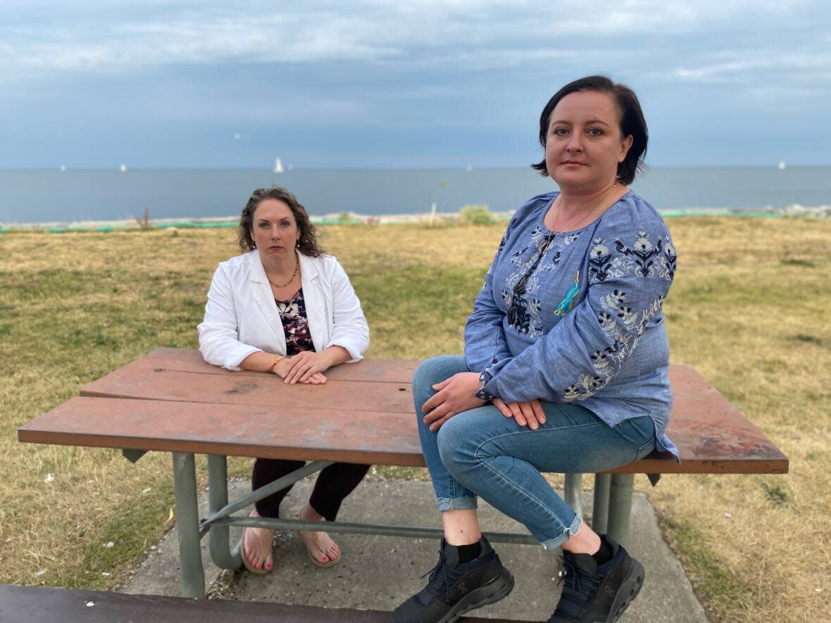 Marissa Andersson (L) and Oksana Kravchuk (R) say they're owed a combined nearly $120,000 in rent, utilities damages and legal costs after their tenants renovated their homes into rooming houses. (Grant Linton/CBC - image credit)