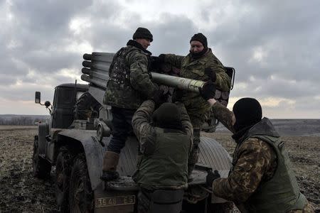 Ukrainian servicemen load Grad rockets before launching them towards pro-Russian separatist forces outside Debaltseve, eastern Ukraine February 8, 2015. REUTERS/Alexei Chernyshev