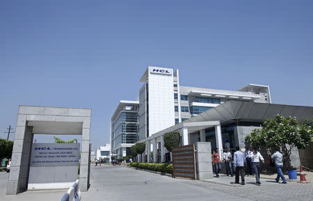 People walk in front of the HCL Technologies Ltd office at Noida, on the outskirts of New Delhi April 17, 2013. REUTERS/Mansi Thapliyal/File Photo