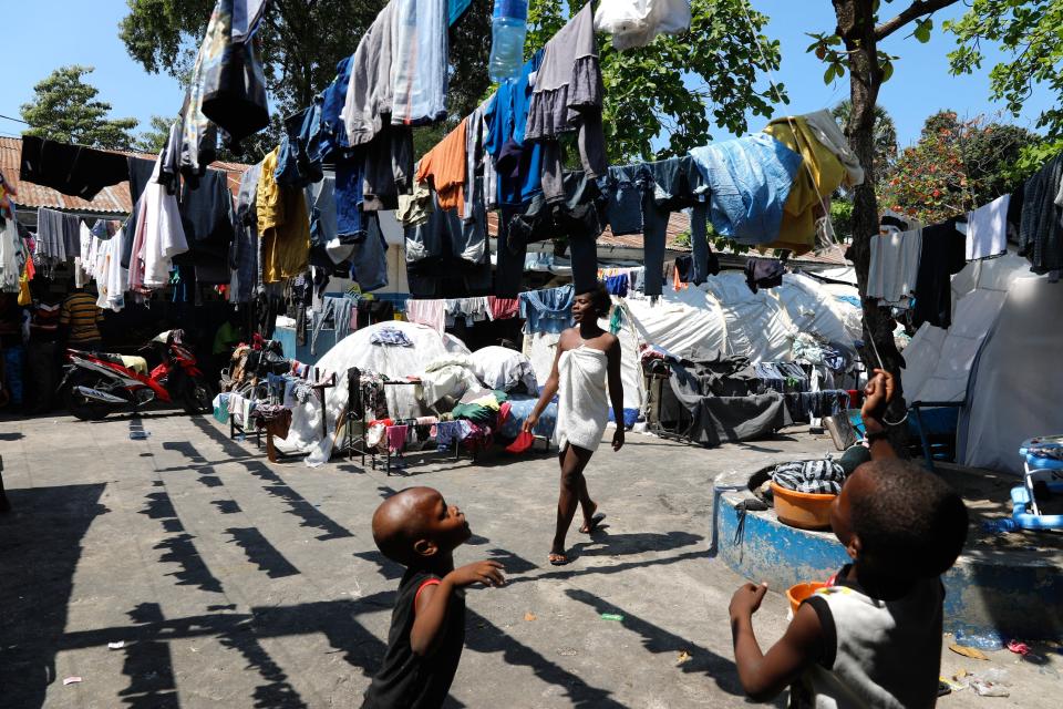 Children play in the courtyard of a shelter for families displaced by gang violence, in Port-au-Prince, Haiti, Thursday, March 14, 2024. (AP Photo/Odelyn Joseph)