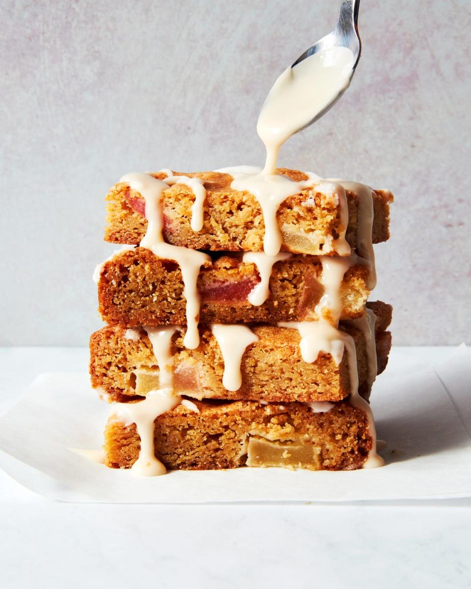 brown butter apple blondies in a stack with glazed drizzled over top