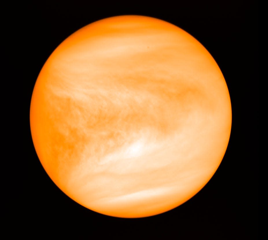 Despite being farther from the Sun than Mercury, Venus is hotter than Mercury because its carbon dioxide and sulfuric acid-filled atmosphere causes a greenhouse effect.