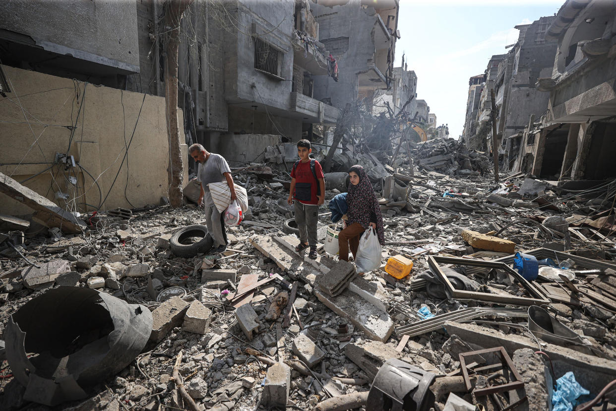 GAZA CITY, GAZA - OCTOBER 16: Palestinians look for their belongings among the rubble of their destroyed houses as Israeli attacks continue on the 10th day in Gaza City, Gaza on October 16, 2023. (Photo by Mustafa Hassona/Anadolu via Getty Images)