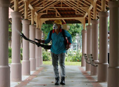 A worker mists the common area of a public housing estate with insecticide, near the vicinity where locally transmitted Zika cases were discovered in Singapore August 30, 2016. REUTERS/Edgar Su