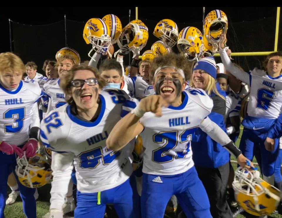 Hull High football players, including Jaden Stilphen, right, and Collin Samya, left, celebrate the Pirates' 39-22 win over Hoosac Valley in the Division 8 state semifinals in Dudley on Friday, Nov. 19, 2021.