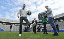 Dallas Stars' John Klingberg, left, plays with a soccer ball as Stars goaltender Ben Bishop, right, Miro Heiskanen, center right, and NHL commissioner Gary Bettman look on while touring the playing field of the Cotton Bowl in Dallas, Wednesday, March 20, 2019. The players and commissioner were on hand to announce the NHL Winter Classic hockey game between the Nashville Predators and the Dallas Stars to be played Jan. 1, 2020, at the Cotton Bowl in Dallas. (AP Photo/LM Otero)