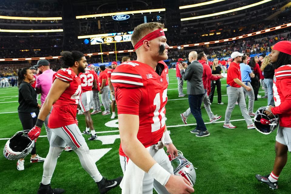 Dec 29, 2023; Arlington, Texas, USA; Ohio State Buckeyes quarterback Lincoln Kienholz (12) walks off the field following the Goodyear Cotton Bowl Classic against the Missouri Tigers at AT&T Stadium. Ohio State lost 14-3.