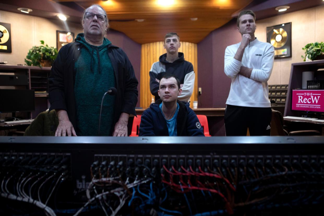 Sam Becker (left), Chief Engineer, stands next to Maxwell Ridenour (blue shirt) at the audio and mixing console along with other students inside one of the studios during a class at the RecW on Jan. 12, 2023. The RecW is a recording workshop that teaches music recording and audio production. Students from around the world have been attending the workshop since 1977.