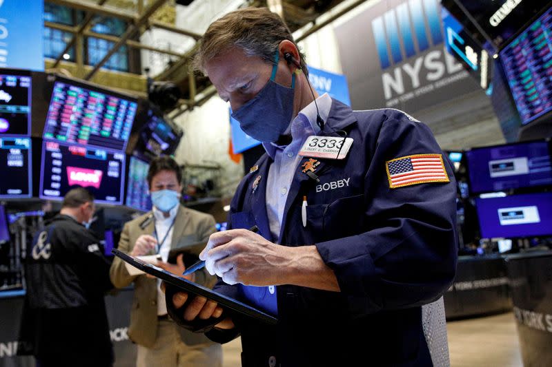 Traders work on the floor of the NYSE in New York