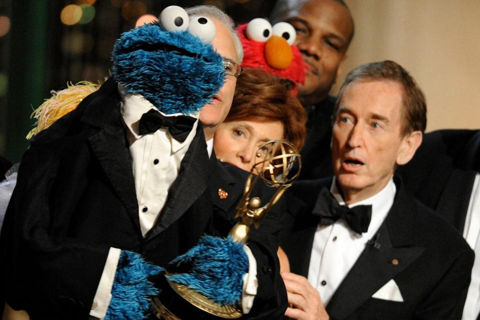 Bob McGrath, right, looks at the Cookie Monster as they accept the Lifetime Achievement Award for '"Sesame Street" at the Daytime Emmy Awards