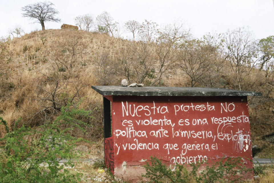 Bus stop at the Ayotzinapa Normal School. Grafitti on the structure reads, "Our protest is not violent, it is a political response to the poverty, exploitation and violence generated by the government."