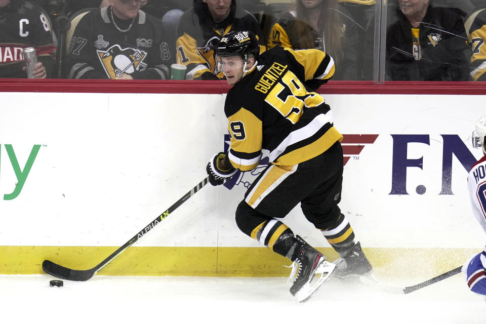 Pittsburgh Penguins' Jake Guentzel looks to pass the puck during the second period of the team's NHL hockey game against the Montreal Canadiens in Pittsburgh, Tuesday, March 14, 2023. (AP Photo/Gene J. Puskar)