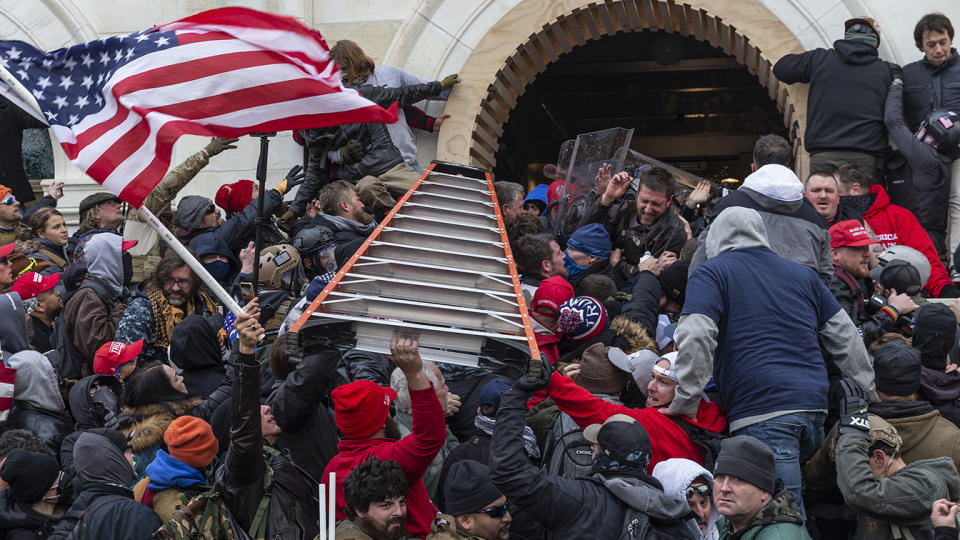 Rioters clash with police using big ladder trying to enter Capitol building through the front doors on Jan. 6, 2020 in Washington, D.C. (Lev Radin/Pacific Press/LightRocket via Getty Images)