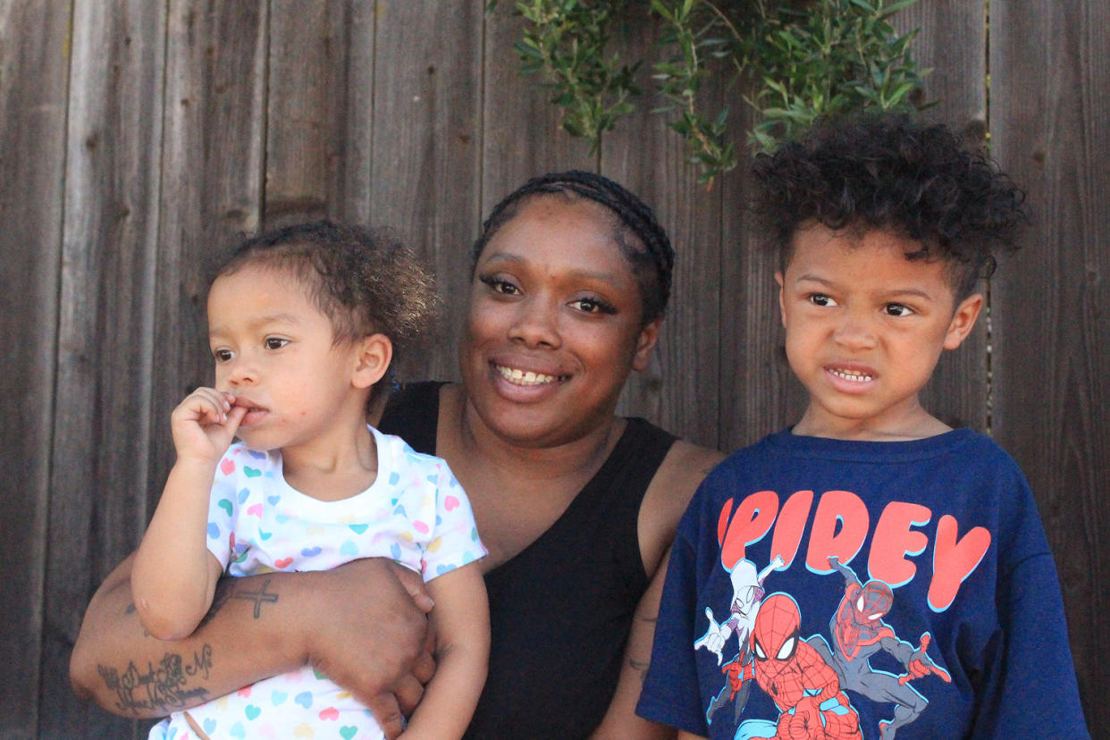 Diola Lucero and her children outside their preschool. (Hoda Emam / NBC News)