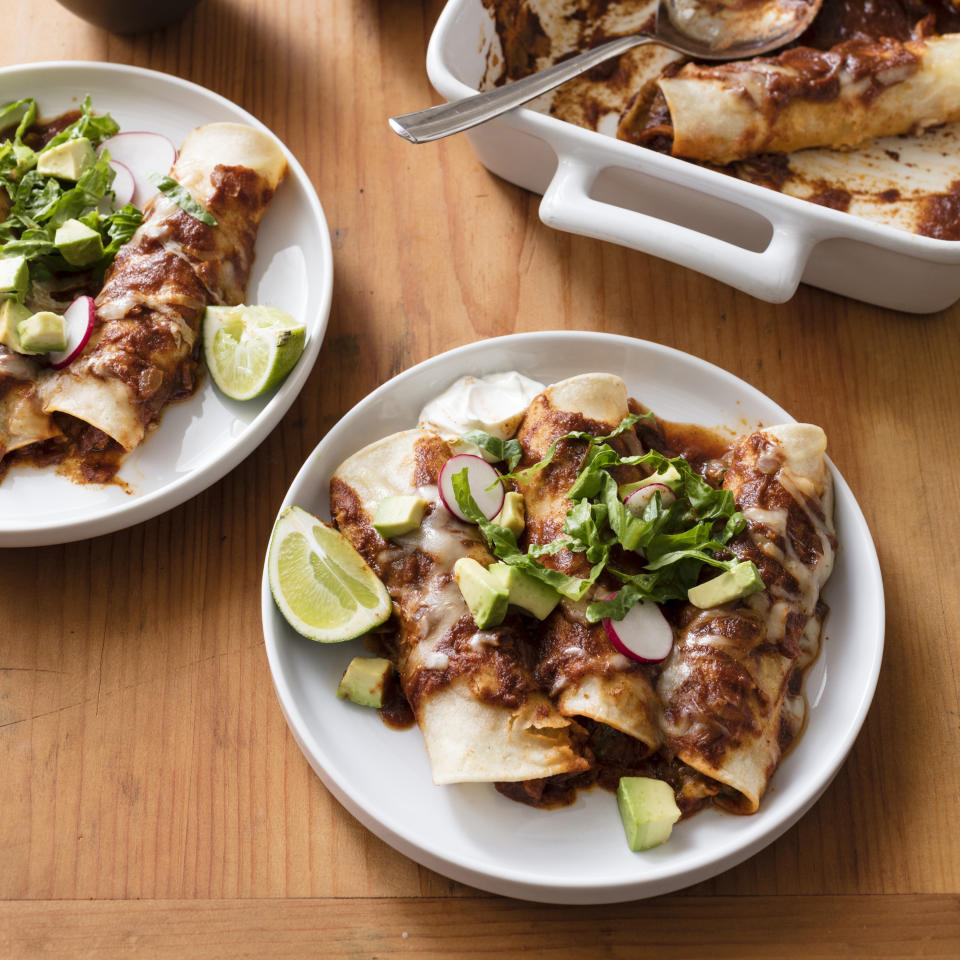 This undated photo provided by America's Test Kitchen in February 2019 shows Chicken Enchiladas in Brookline, Mass. This recipe appears in the cookbook "The Complete Slow Cooker." (Daniel J. van Ackere/America's Test Kitchen via AP)