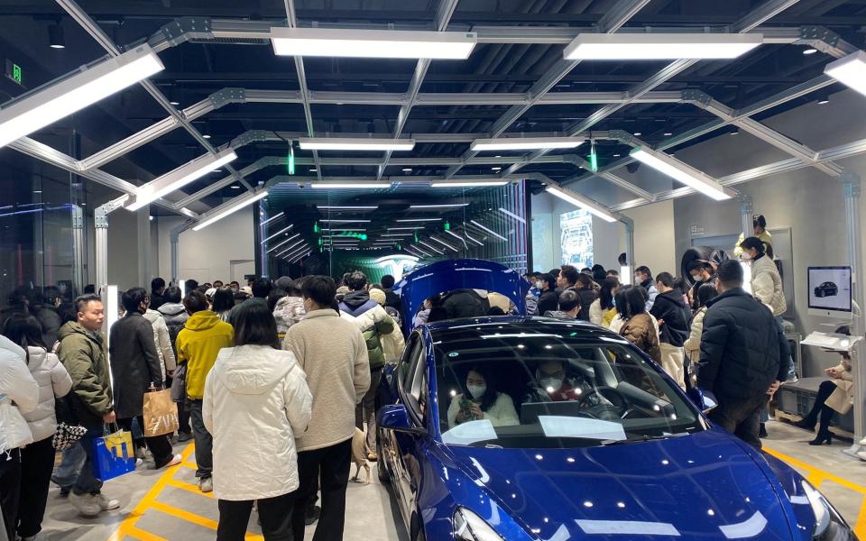 People protest at a Tesla showroom in Chengdu, Sichuan, China - Reuters