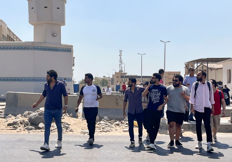 FILE PHOTO: Alaa Essam, one of a group of newly released detainees walks across the road with his family and friends after leaving Tora prison in a suburb of Cairo