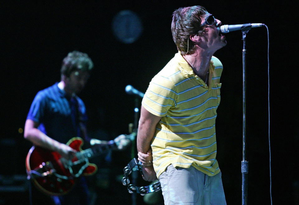 BENICASIM, SPAIN:  British Liam (R) and Noel Gallagher, members of group "Oasis" perform during their concert at the Benicasim International Festival in Benicasim, Castellon, 07 August 2005.   AFP PHOTO/JOSE JORDAN  (Photo credit should read JOSE JORDAN/AFP/Getty Images)