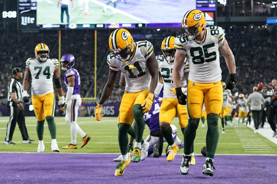 Green Bay Packers' Jayden Reed (11) celebrates after his touchdown catch during the first half of an NFL football game against the Minnesota Vikings Sunday, Dec. 31, 2023, in Minneapolis. (AP Photo/Abbie Parr)
