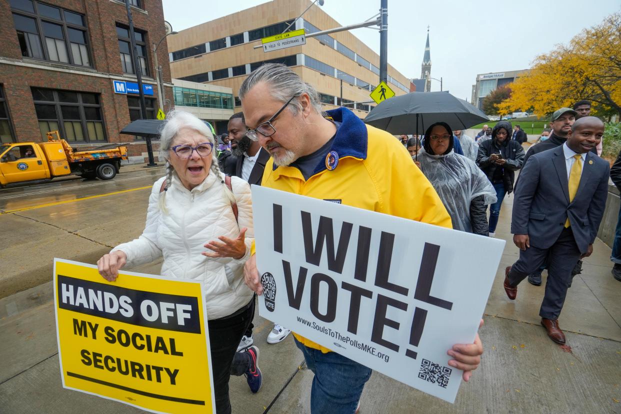 Milwaukee Mayor Cavalier Johnson, right, walks to Fiserv Forum following his speech during a visit to MATC Tuesday to encourage early voting.