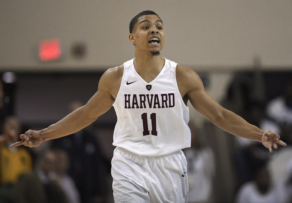 Harvard's Bryce Aiken gestures after scoring a three-point basket during the first half of an NCAA college basketball game for the Ivy League championship against Yale in New Haven, Conn., Sunday, March 17, 2019, in New Haven, Conn. (AP Photo/Jessica Hill)