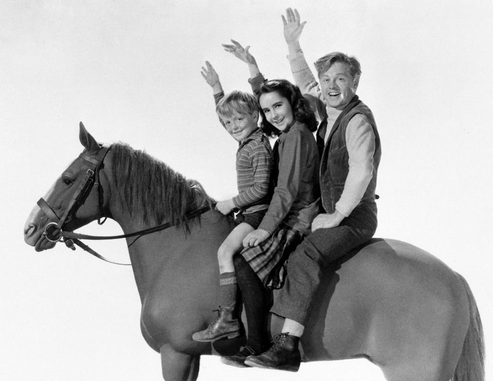 This 1945 file publicity image for the film "National Velvet," shows, from left, actors Butch Jenkins, Elizabeth Taylor and Mickey Rooney. Rooney, a Hollywood legend whose career spanned more than 80 years, died Sunday, April 6, 2014, at his North Hollywood, Calif. home. He was 93. (AP Photo/File)