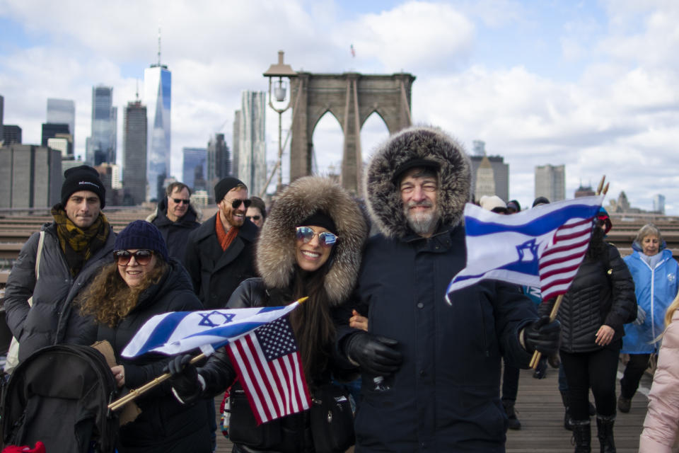 People take part in a march crossing the Brooklyn Bridge in solidarity with the Jewish community after recent string of anti-semitic attacks throughout the greater New York area, on Sunday, Jan. 5, 2020 in New York. (AP Photo/Eduardo Munoz Alvarez)